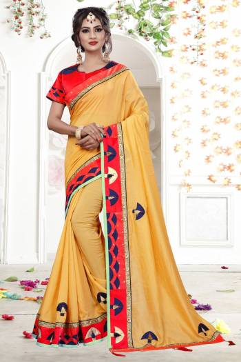 Celebrate This Festive Season Wearing This Designer Saree In Yellow Color Paired With Contrasting Red Colored Blouse. This Saree Is Fabricated On Fancy Georgette Paired With Art Silk Fabricated Blouse. It Has Pretty Elegant Embroidery All Over The Saree.