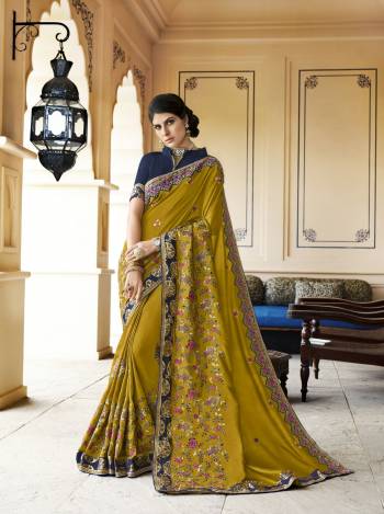 New And Unique Shade Is Here To Add Into Your Wardrobe, Grab This Designer Saree In Pear Green Color Paired With Contrasting Dark Blue Colored Blouse. This Saree Is Fabricated On Soft Silk Paired With Art Silk Fabricated Blouse. It Has Contrasting Floral Embroidery Over The Saree. 