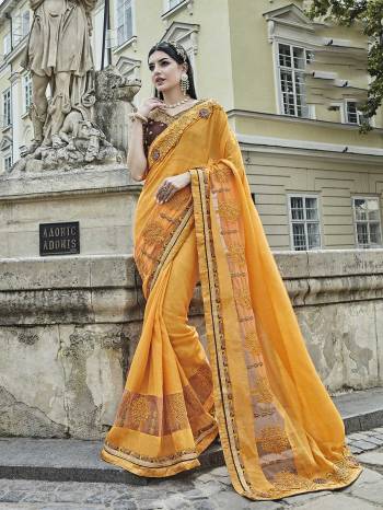 Celebrate This Festive Season Wearing This Designer Saree In Yellow Color Paired With Contrasting Brown Colored Blouse. This Saree Is Fabricated On Silk Chiffon Paired With Art Silk Fabricated Blouse. It Is Beautufied With Resham And Jari Embroidery. Buy Now.