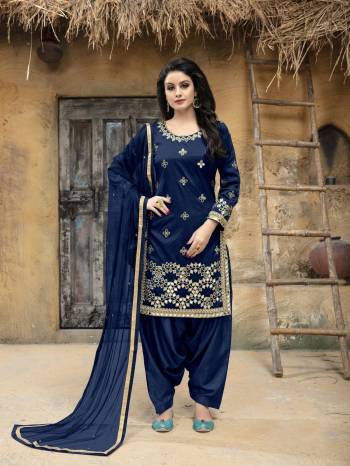 Enhance Your Personality Wearing This Designer Salwar Suit In Dark Blue Color. This Semi-Stitched Suit Has Art Silk Fabricated Top Paired With Santoon Bottom And Net Dupatta. It Is Beautified With Jari Embroidery and Mirror Work. Buy This Attractive Looking Suit Now.