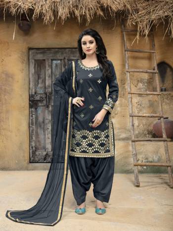 Enhance Your Personality Wearing This Designer Salwar Suit In Dark Grey Color. This Semi-Stitched Suit Has Art Silk Fabricated Top Paired With Santoon Bottom And Net Dupatta. It Is Beautified With Jari Embroidery and Mirror Work. Buy This Attractive Looking Suit Now.