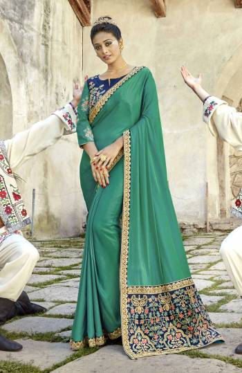 New Shade In Green Is A Must Have In Every Womens Wardrobe, Grab This Designer Saree In Teal Green Color Paired With Contrasting Navy Blue Colored Blouse. This Saree Is Fabricated On Satin Silk Paired With Art Silk Blouse. Buy This Saree Now.