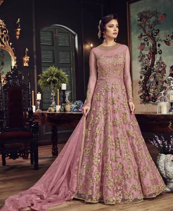 Look The Most Prettiest Of All Wearing This Heavy Designer Floor Length Suit In Pink Color Paired With Pink Colored Bottom And Dupatta. Its Top And Dupatta Are Net Fabricated Paired With Santoon Bottom. Buy Now.