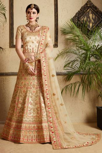 Flaunt Your Rich And Elegant Taste With This Subtle Colored Designer Lehenga Choli In Beige Color Paired With Beige Colored Bottom And Dupatta. Its Blouse And Lehenga Are Fabricated On Satin Paired With Net Dupatta. It Is Beautified With Contrasting Resham And Jari Embroidery With Stone Work.