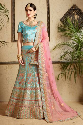 Look Pretty Wearing This Heavy Designer Lehenga Choli In Sky Blue Color Paired With Contrasting Light Pink Colored Dupatta. Its Blouse And Lehenga Are Satin Based Fabric Paired With Net Dupatta. It Has Heavy Embroidery All Over. Buy Now.