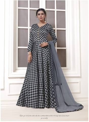 Get Ready For The Upcoming Party With This Designer Floor Length Suit In Grey And Black Color Paired With Black Grey Colored Bottom And Dupatta. It IS Beautified With Checks Prints All Over Its Top.