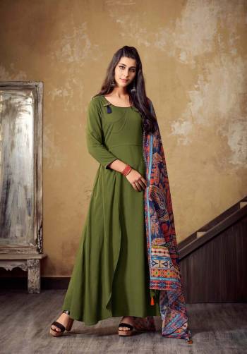 You Will Definitely Earn Lots Of Compliments Wearing This Designer Readymade Kurti In Olive Green Color Paired With Multi Colored Scarf. This Kurti IS Rayon Based Paired With Muslin Cotton Scarf. Get This Amazing Kurti Now.