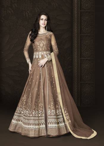 You Will Definitely Earn Lots Of Compliments Wearing This Heavy Designer Floor Length Suit In Brown Color Paired With Brown Colored Bottom And Dupatta. Its Rich Color And Embroidery Is Making The Suit Attractive. Buy This Net Based Floor Length Suit Now.