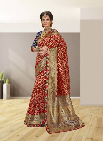 Bright And Visually Appealing Color Is Here With This Saree In Red Color Paired With Contrasting Navy Blue Colored Blouse. This Saree And Blouse Are Fabricated On Jacquard Silk Beautified With Weave And Embroidered Lace Border. Buy This Saree Now.