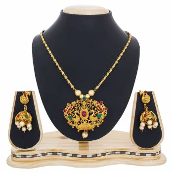 For An elegant And Simple Look, Grab This Pretty Necklace Set In Golden Color Beautified With Green And Pink Colored Stone Work, It Can Be Paired With Any Contrasting Ethnic Attire.