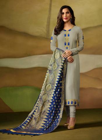 Flaunt Your Rich And Elegant Taste Wearing This Designer Straight Cut Suit In Light Grey Color Paired With Contrasting Royal Blue Colored Dupatta. Its Top Is Fabricated On Satin Georgette Paired With Santoon Bottom Bansarasi Silk Dupatta. Buy Now.