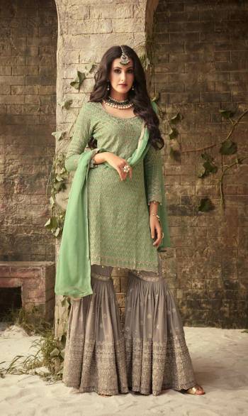 A Must Have Color Pallete To Add Into Your Wardrobe With This Designer Sharara Patterned Suit In Light Green Colored Top And Dupatta Paired With Contrasting Grey Colored Bottom. Its Top and Bottom are Fabricated On Georgette Beautified With Heavy Embroidery Paired With Chiffon Dupatta.