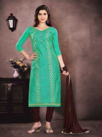 Here Is An Attractive Looking Dress Material In Green Colored Top Paired With Brown Colored Bottom And Dupatta. Get This Beautiful Dress Material Stitched As Per Your Desired Fit And Comfort. Buy Now.