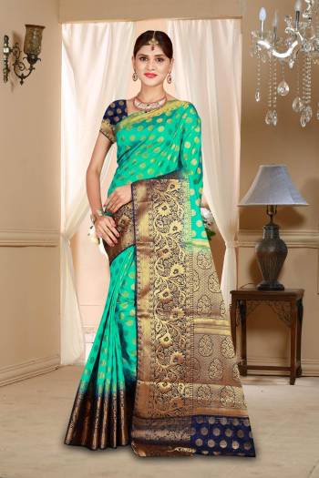 Catch All The Limelight Wearing This Pretty Attractive Sea Green Colored Saree Paired With Contrasting Navy Blue Colored Blouse. This Saree And Blouse Are Art Silk Based Beautified With Weave All Over It. 