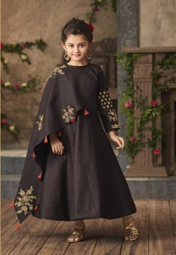 Make Your Little Princess Trendy With Yourself With This Designer Floor Length Gown In Dark Brown Color Fabricated On Satin Silk. It Has Unique One Side Cape Pattern Will Give You And Your Daughter A Look Like Never Before. Buy Now.