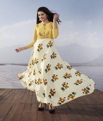 Grab This Designer Long Kurti In White And Yellow Color Fabricated On Satin Georgette. It Is Beautified With Floral Prints And Embroidery Over The Yoke. Buy Now.