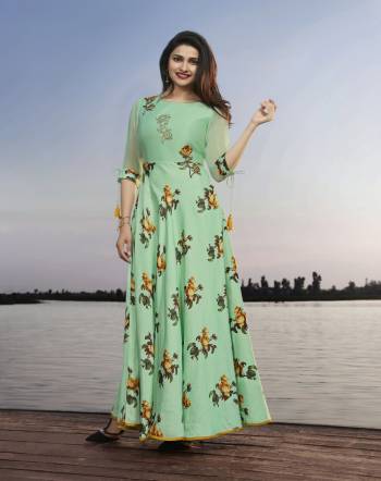 Look Pretty In This Designer Floor Length Readymade Kurti In Light Green Color Fabricated On Satin Georgette Beautified With Prints And Embroidery. It Is Available In All Regular Sizes. Buy Now.