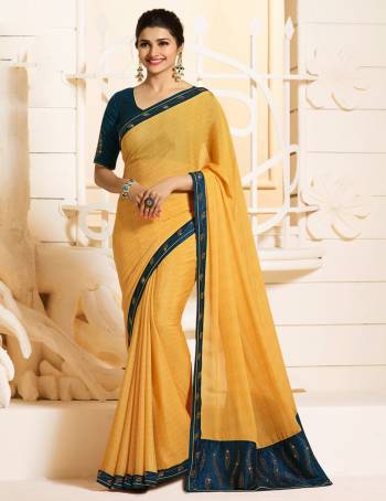 Celebrate This Festive Season With Beauty And Comfort Wearing This Lovely Designer Saree In Yellow Color Paired With Contrasting Prussian Blue Colored Blouse. This Saree Is Georgette Based Paired With Art Silk Fabricated Blouse. Buy Now.