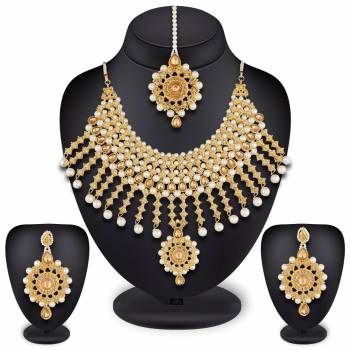 For A Heavy Royal Look, Grab This Beautiful Necklace Set With A Pair Of Earrings And Maang Tika. This Necklace Set Can Be Paired With Any Colored Heavy Traditonal Attire. Buy This Necklace Set Now.