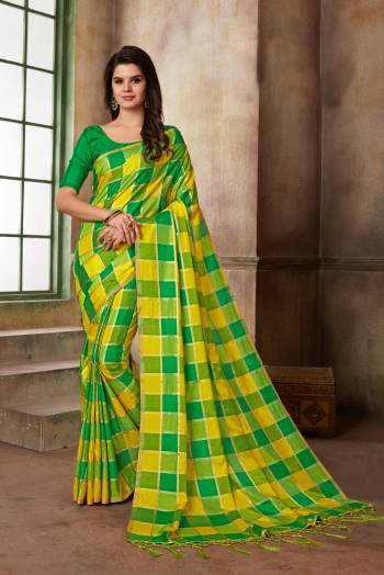 Look Pretty In This Yellow And Green Colored Saree Paired With Contrasting Green Colored Blouse. This Saree And Blouse Are Silk Based Beautified With Checks Prints all Over It.