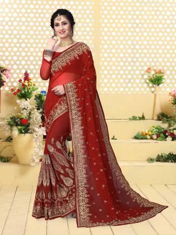 Here Is A Royal And Attractive Looking Maroon Colored Saree Paired With Maroon Colored Blouse. This Saree And Blouse Are Fabricated On Georgette Beautified With Jari Embroidery Making It More Attractive. 