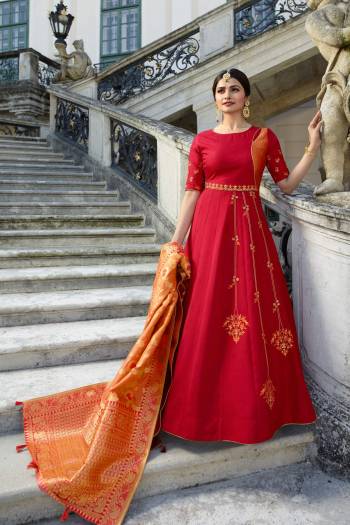 Adorn The Pretty Angelic Look Wearing This Designer Floor Length Gown In Red Color Paired With Orange Colored Dupatta. This Silk based Suit With Embroidery Will Give A Rich Look To Your Personality. Buy Now.