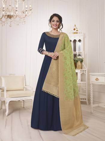 Enhance Your Personality Wearing This Designer Floor Length Semi-Stitched Suit In Navy Blue Color Paired With Contrasting Light Green Colored Dupatta. Its Top Is Fabricated On Muslin Silk Paired With Santoon Bottom And Banarasi Silk Dupatta. 