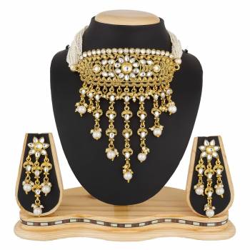 Another Heavy Choker Necklace Set IS Here In Golden Color Beautified With White Colored Stone And Moti Work. This Can Be Paired With Any Colored Traditional Attire.