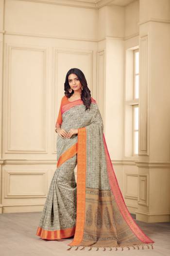 Flaunt Your Rich And Elegant Taste Wearing This Saree In Grey Color Paired With Contrasting Orange Colored Blouse. This Saree And Blouse Are Silk Based Beautified With Prints. 