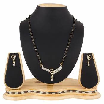 Give An Elegant Look To Your Neckline With This Rich Designer Mangalsutra Set Beautified With Diamond Work. Also It Comes With A Pair OF Earrings. Pair This Up With Any Colored Attire, Be It Casual Or Heavy. 