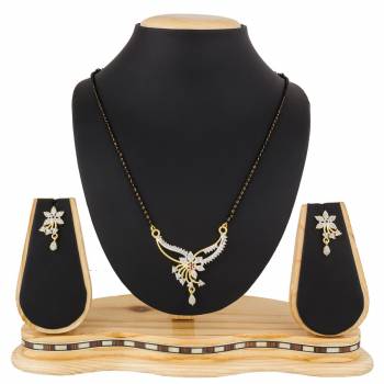 Give An Elegant Look To Your Neckline With This Rich Designer Mangalsutra Set Beautified With Diamond Work. Also It Comes With A Pair OF Earrings. Pair This Up With Any Colored Attire, Be It Casual Or Heavy. 