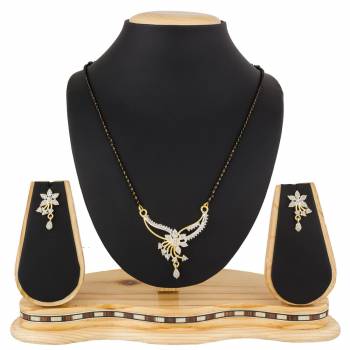 Give An Elegant Look To Your Neckline With This Rich Designer Mangalsutra Set Beautified With Diamond Work. Also It Comes With A Pair OF Earrings. Pair This Up With Any Colored Attire, Be It Casual Or Heavy. 