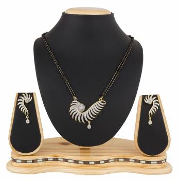 Give An Elegant Look To Your Neckline With This Rich Designer Mangalsutra Set Beautified With Diamond Work. Also It Comes With A Pair OF Earrings. Pair This Up With Any Colored Attire, Be It Casual Or Heavy. 