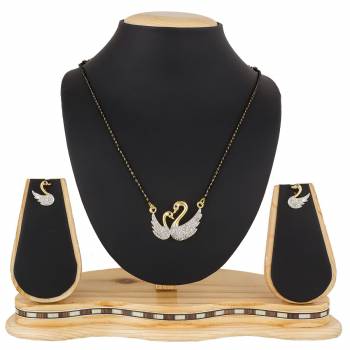 Give An Elegant Look To Your Neckline With This Rich Designer Mangalsutra Set Beautified With Diamond Work. Also It Comes With A Pair OF Earrings. Pair This Up With Any Colored Attire, Be It Casual Or Heavy. 