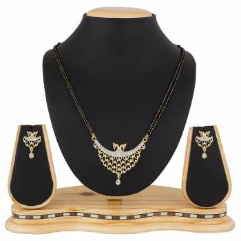 Give An Elegant Look To Your Neckline With This Rich Designer Mangalsutra Set Beautified With Diamond Work. Also It Comes With A Pair OF Earrings. Pair This Up With Any Colored Attire, Be It Casual Or Heavy. 