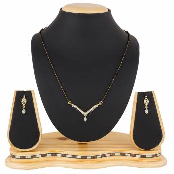 Give An Elegant Look To Your Neckline With This Rich Designer Mangalsutra Set Beautified With Diamond Work. Also It Comes With A Pair OF Earrings. Pair This Up With Any Colored Attire, Be It Casual Or Heavy. 