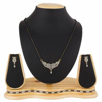 Give An Elegant Look To Your Neckline With This Rich Designer Mangalsutra Set Beautified With Diamond Work. Also It Comes With A Pair OF Earrings. Pair This Up With Any Colored Attire, Be It Casual Or Heavy. 