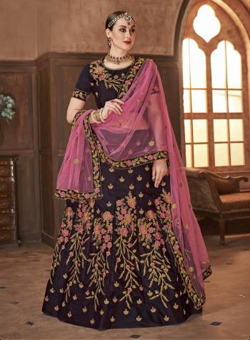 Here Is A Beautiful Shade With This Heavy Designer Lehenga Choli In Wine Color Paired With Contrasting Pink Colored Dupatta. Its Is Satin Silk Based Paired With Net Fabricated Dupatta, Buy Now.