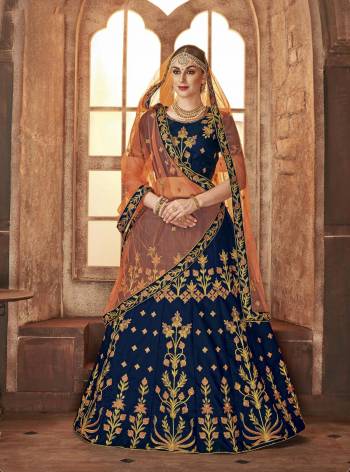 Add This Beautiful Heavy Designer Lehenga Choli In Blue Color Paired With Contrasting Light Orange Colored Dupatta. Its IS Satin Silk Based Paired With Net Fabricated Dupatta. Buy This Now.