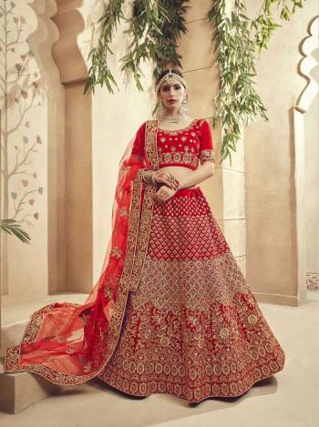 Get Ready For The D-Day With This Beautiful Heavy Designer Lehenga Choli In Red Color Paired With Red Colored Dupatta. Its Blouse And Lehenga Are Velvet Fabricated Paired With Net Fabricated Dupatta. It Has Heavy Embroidery All Over It Giving It A Lovely Glam Look.