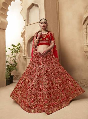 Get Ready For The D-Day With This Beautiful Heavy Designer Lehenga Choli In Red Color Paired With Red Colored Dupatta. Its Blouse And Lehenga Are Velvet Fabricated Paired With Net Fabricated Dupatta. It Has Heavy Embroidery All Over It Giving It A Lovely Glam Look.