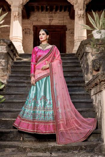 Here Is A Beautiful Heavy Designer Lehenga Choli In Dark Pink Colored Blouse Paired With Sky Blue Colored Lehenga And Baby Pink Colored Dupatta. Its Blouse And Lehenga Are Satin Fabricated Paired With Net Fabricated Dupatta. Buy Now.