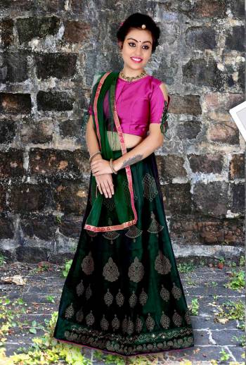 This Wedding Season, Give A Unqiue Look To Your Wear Making Her Wear This Beautiful Lehenga Choli In Rani Pink Colored Blouse Paired With Contrasting Dark Green Colored Lehenga And Dupatta. Its Blouse And Lehenga Are Soft Silk Based Paired With Net Dupatta. all Its Fabrics Ensures Superb Comfort Throughout The Gala.