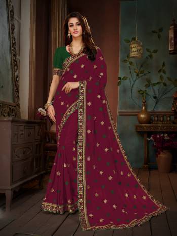 Add This Beautiful Designer Saree To Your Wardrobe In Magenta Pink Color Paired With Contrasting Green Colored Blouse. This Saree And Blouse Are Silk based Beautified With Embroidery All Over. This Saree Is Suitable For Party Or Any Festive Wear.