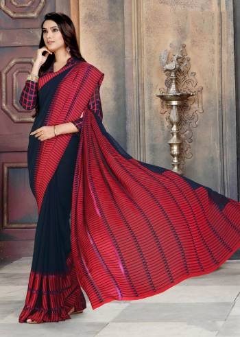 For A Bold and Beautiful Look, Grab This Georgette Based Saree In Navy Blue And Red Color Paired With Navy Blue And Red Colored Blouse. It Has Pretty Satin Patta With Polka Prints Over Border. 