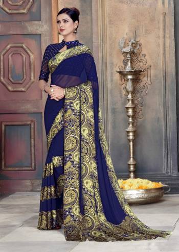 For A Bold and Beautiful Look, Grab This Georgette Based Saree In Navy Blue Color Paired With Navy Blue Colored Blouse. It Has Pretty Satin Patta With Prints Over Border. 