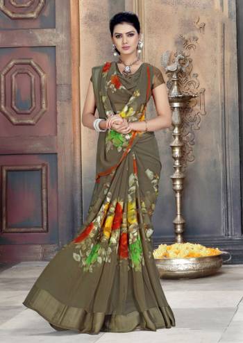 Add This New Shade To Your Wardrobe With This Designer Saree In Sand Grey Color Paired With Sand Grey Colored Blouse. This Saree And Blouse Are Georgette Based Beautified With Prints And Satin Patta. 