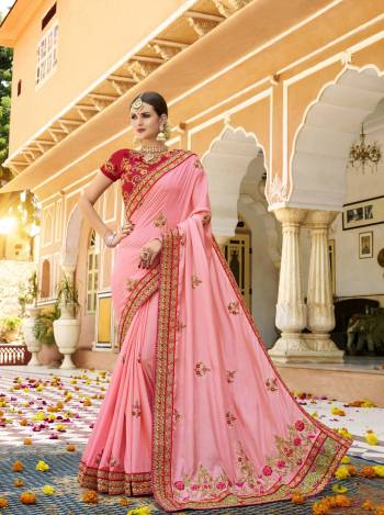 Look Pretty In This Lovely Light Pink Colored Saree Paired With Contrasting Red Colored Blouse. This Saree And Blouse Are Silk Based Beautified With Heavy Embroidery Over The Saree And Blouse. Buy Now.