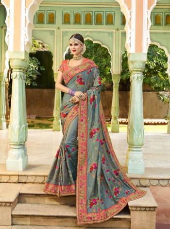 Flaunt Your Rich And Elegant Taste Wearing This Saree In Grey Color Paired With Contrasting Orange Colored Blouse, This Saree And Blouse Are Silk Beautified With Heavy work. Also Its Rich Color Pallete Will Earn You Lots Compliments.