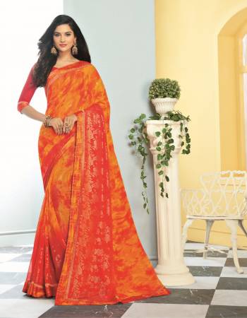 Orange And Red Color Induces Perfect Summery Appeal To Any Outfit, So Grab This Saree In Orange Color Paired With Contrasting Red Colored Blouse. This Saree Is Georgette Based Paired With Satin Fabricated Blouse. 